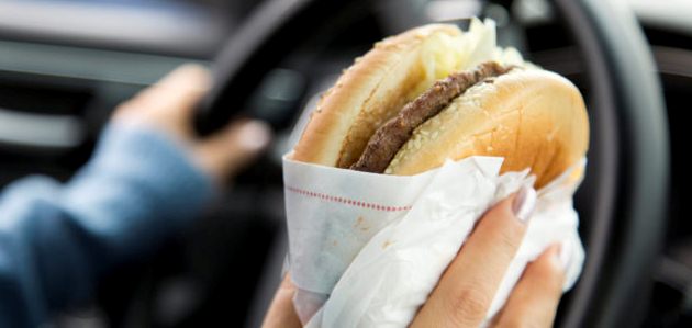 eating burger while driving